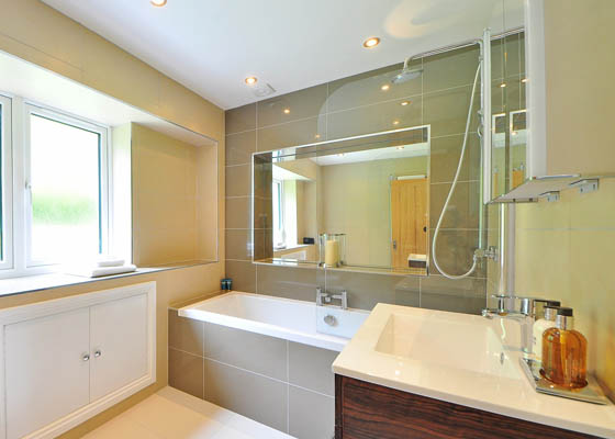 Photo of Harwood Carpentry Limited Salisbury Wiltshire bathroom refit with glass mirrors